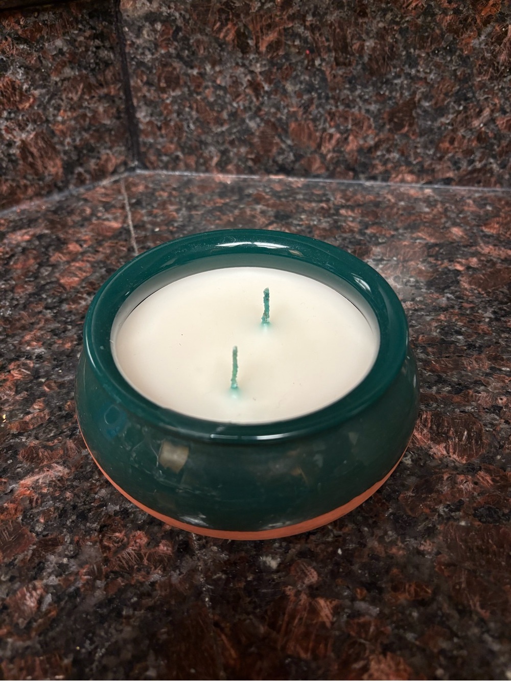 Handmade upcycled candle floral scented wax in a Green and orange terracotta jar